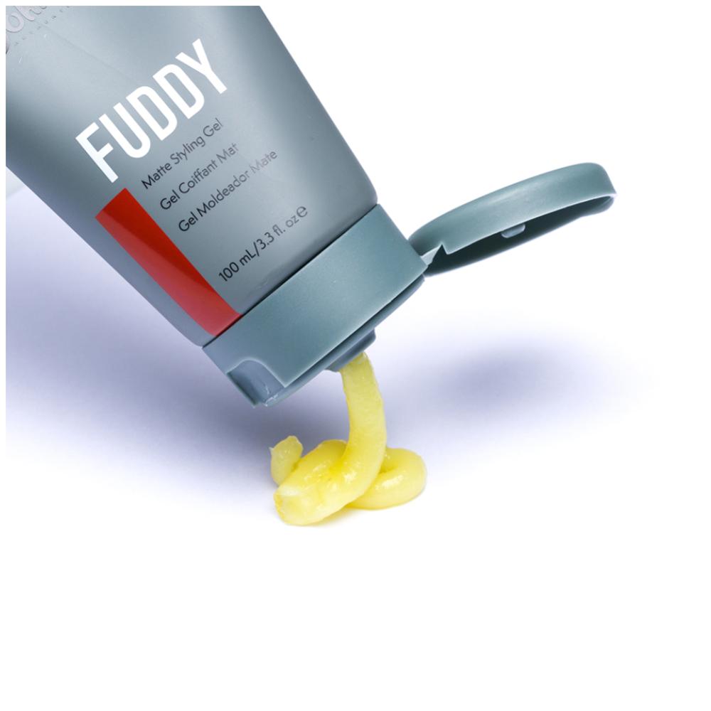 Johnny B Fuddy Matte Styling Gel in a clear jar with black lid, showing the product's matte finish and logo on the label.