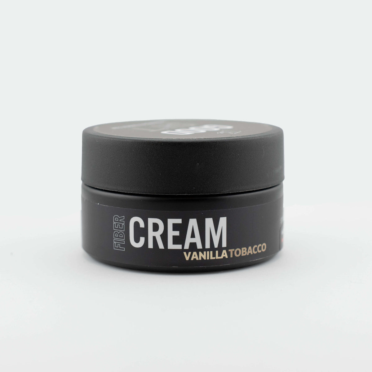 Fiber cream pomade from The Good Sh*t Men's Grooming with a jar of styling product and textured hair.