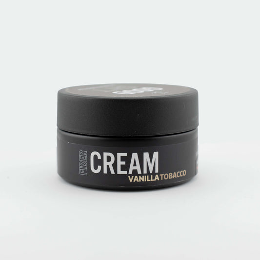 Fiber cream pomade from The Good Sh*t Men's Grooming with a jar of styling product and textured hair.