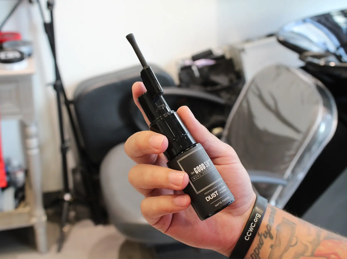 The Good Sh*t Dust Volumizing Powder for men, styling product in a sleek container, designed to add volume and texture to hair.