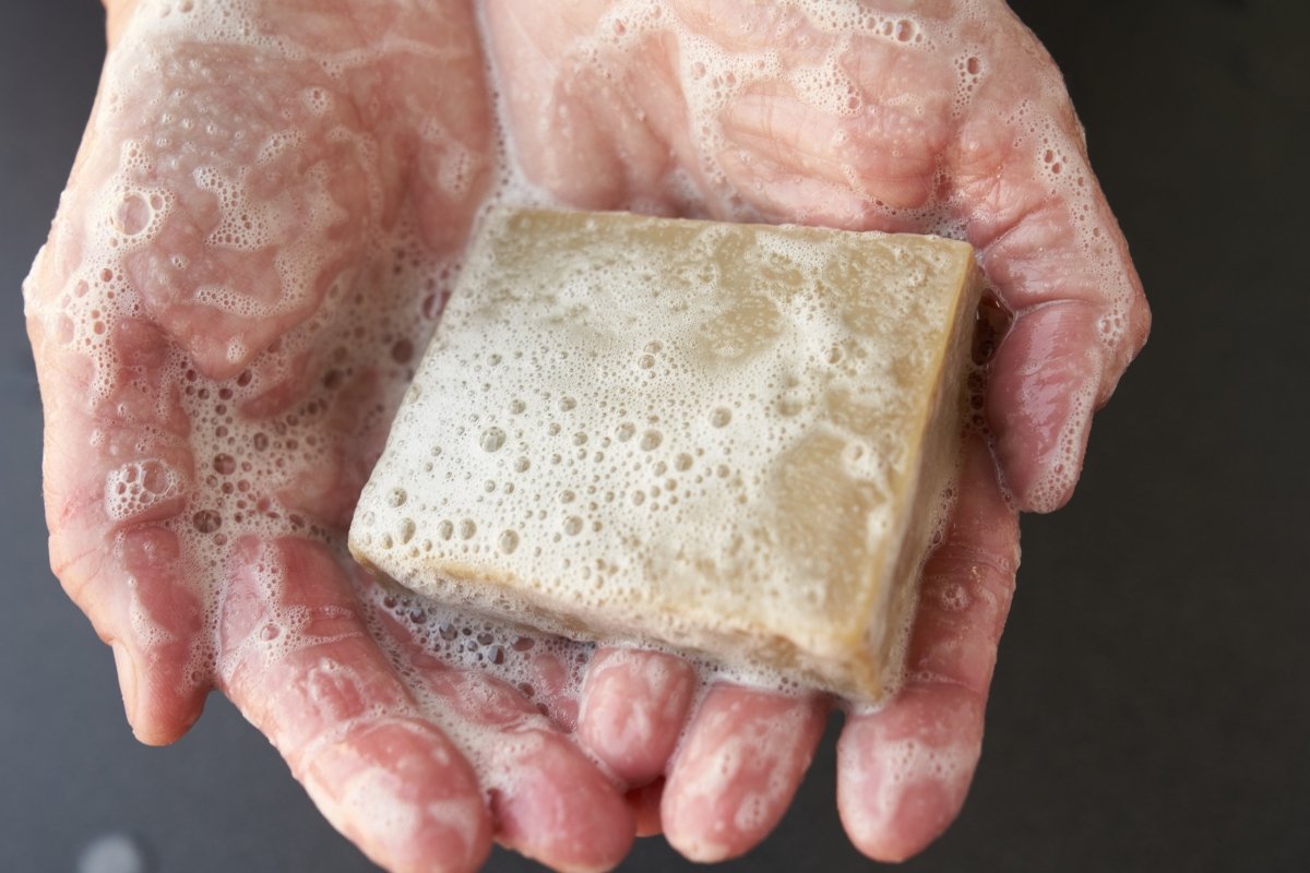 Zingari Man The Watchman Bath Bar shampoo and conditioner with natural ingredients, shown as a sleek soap bar in a bathroom setting.