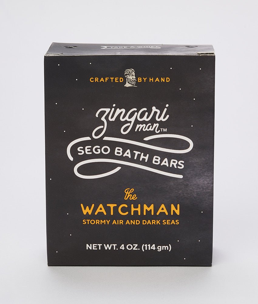 Zingari Man The Watchman Bath Bar shampoo and conditioner bar shown in a natural setting with packaging and product details.